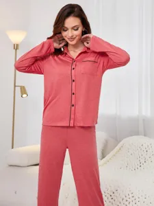 Detailed view of women's casual long sleeve button down pajama top and lounge pants set.