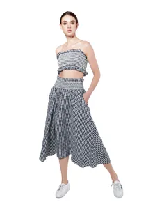 Detail view of the black and white gingham two piece outfit, strapless top and skirt.