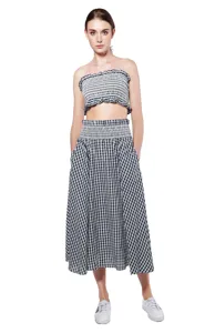 Detail view of the black and white checkered strapless top and long skirt set features.