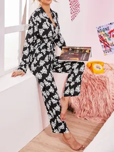 Detailed view of women's black and white floral print long sleeve pajama set in cozy room.