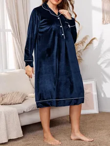 Detail view of the long sleeve velvet nightgown featuring chic contrast piping and lapel collar.