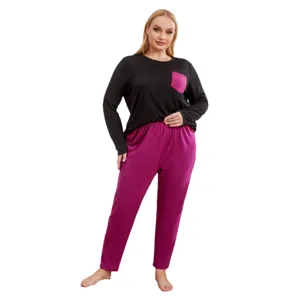 Plus size long sleeve pajamas set for women, black top with pink pocket and pink lounge pants.