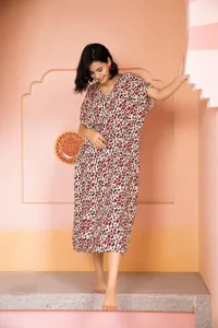 Detail view of women summer short sleeve leopard print midi dress in cozy indoor studio setting
