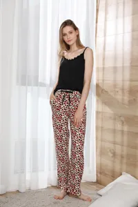 Detail view of women's sexy camisole pajama set featuring a black top and leopard pants.