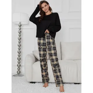 Women's long sleeve pajama set with black top and plaid printed pants for comfortable home wear.