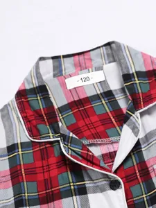 Kids plaid long sleeve pajama top detail, classic red tartan check shirt collar with buttons.
