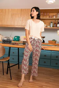 Detailed view of women's comfortable loungewear set featuring a peach top and leopard pants.