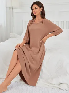 Close-up detail of the comfortable long-sleeve V-neck lounge dress in soft brown fabric.