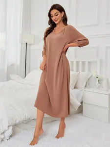 Detail view of women's long sleeve V-neck casual loungewear dress in solid brown, comfortable texture.