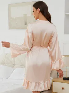 Silky satin long sleeve sleep robe for women, elegant pink nightwear with ruffle hem and belt.