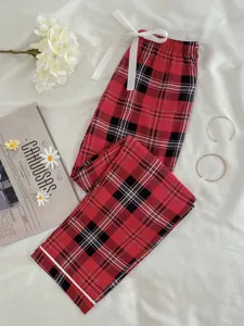 Red black plaid pajama pants lounge trousers with white ribbon drawstring detail flat lay