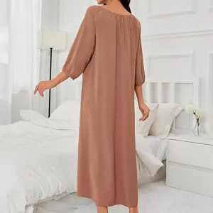 Comfortable long-sleeve casual women's nightgown in solid brown, back view in bedroom setting.