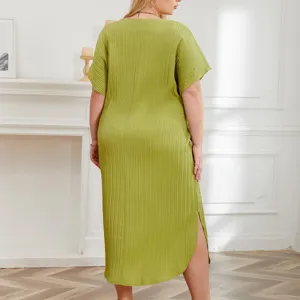 Plus size pleated casual loungewear dress with short dolman sleeves and side slit in green.