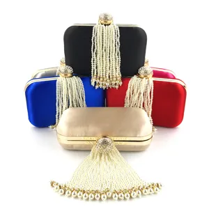 Detailed view of women evening clutch bag with pearl fringe and sparkly rhinestone clasp.
