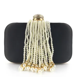 Black beaded evening bag with pearl tassels and rhinestone clasp for women elegant party use.