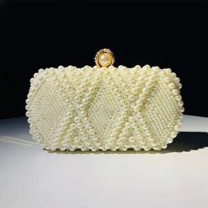 Elegant pearl beaded evening clutch detail, exquisite quilted diamond pattern and shiny gold clasp.