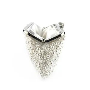 Exquisite handmade pearl evening clutch bag featuring a metal frame and sparkling clasp detail.