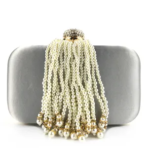 Grey satin evening clutch bag featuring elegant pearl tassel and rhinestone clasp detail.