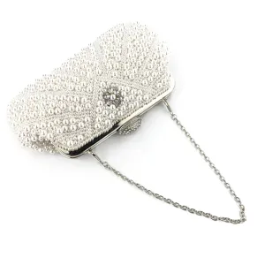 Handmade pearl evening clutch bag detail showing delicate beadwork and silver chain strap.