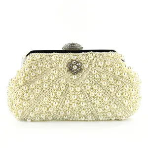 Close-up detail of the elegant pearl beaded evening clutch showing exquisite craftsmanship.