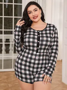 Close-up detail of plus-size plaid onesie featuring cute red hearts and button front.