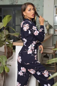 Women's long sleeve floral pajama set with waist tie, comfortable nightwear detail view.
