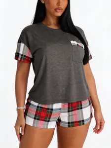 Closeup detail of the plaid pocket and sleeve trim on soft grey summer sleepwear top.