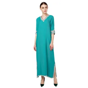 Detailed view of women long sleeve maxi dress V-neck teal dress with intricate embroidery