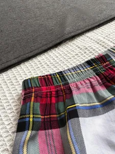 Women's plaid pajama shorts and top set, comfortable casual sleepwear for home relax.