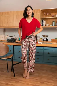 Detail view of women summer pajama set, casual red short sleeve top and leopard print pants.