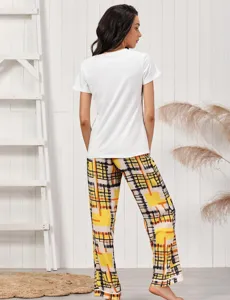 Detail view of women's short-sleeve pajama set with stylish yellow geometric print long pants.