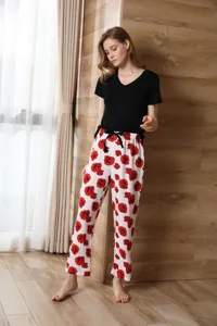 Women summer loungewear detail, black short sleeve top and red rose print pants set.