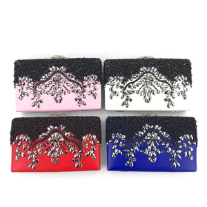 Elegant evening clutch bag featuring handmade black bead embroidery and sparkling rhinestone details.