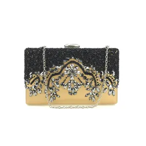 Elegant gold evening clutch bag with black beadwork and sparkling rhinestones for women.