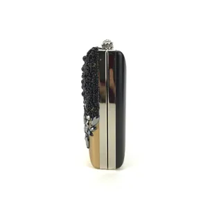 Close-up detail of the side profile showing exquisite black beadwork and metal frame design.