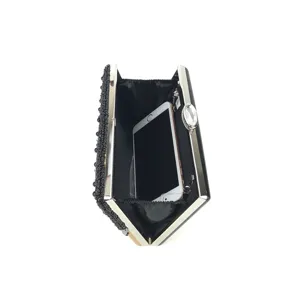 Detailed view of black beaded evening clutch showcasing interior capacity and silver metal frame.