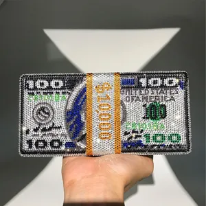 Rhinestone dollar bill clutch bag detail, sparkling crystal money purse close-up view.