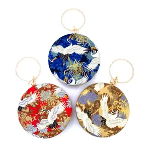 Round evening clutch bag with crane print and metal ring handle for women party use.