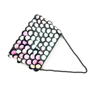 Detailed close-up of the elegant gradient sequin evening clutch bag with nice beaded chain.