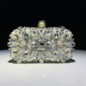 Elegant rhinestone evening clutch bag with sparkling crystals and pearl clasp for parties.