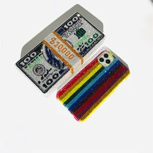 Rhinestone cash stack clutch bag and colorful striped phone case set for evening parties.