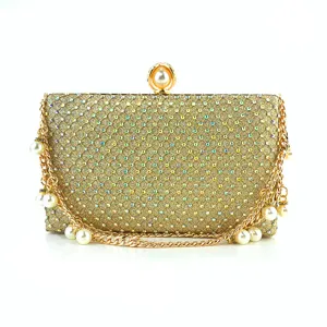 Gold rhinestone evening clutch detail, sparkle crystal surface with pearl clasp and chain.