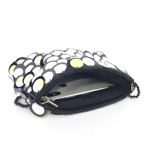 Handcrafted sequin beaded evening clutch bag interior detail showing practical capacity.