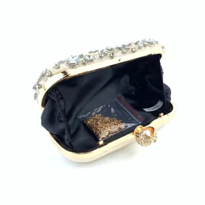 Detail view of a luxurious rhinestone embellished evening clutch with a elegant gold frame.