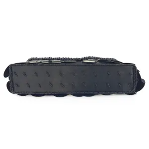 Black handmade beaded evening clutch bag bottom detail showing exquisite sequin craftsmanship.