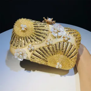 Exquisite gold sequin clutch bag with pearls and shell flower design for evening wedding events.