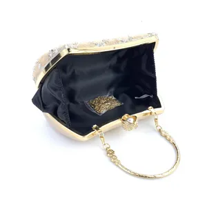 Elegant women's beaded evening clutch bag with metallic gold frame and handle for party.