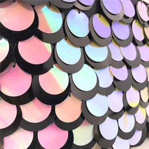 Shimmering gradient scale sequin clutch bag detail shot, stunning evening party accessory.