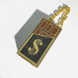 Detail of rhinestone novelty clutch featuring dollar sign and chocolate design with gold chain.