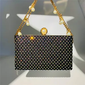 Details of the black rhinestone evening clutch bag with pearl chain strap and crystals.